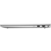 Srebrny laptop widziany z boku, z zamkniętą pokrywą, ukazujący porty: USB, Ethernet oraz gniazdo zasilania. Urządzenie ma smukły profil i minimalistyczny design.