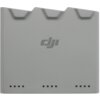 Szary hub z logo "dji" na środku, posiadający trzy wycięcia na górnej krawędzi oraz rząd małych, czarnych kwadratowych wskaźników na dole.