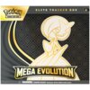Pudełko z grą karcianą z grafiką postaci oraz napisami: "Pokémon Trading Card Game", "Elite Trainer Box", "Mega Evolution". Na dole znajduje się ostrzeżenie: "WARNING: CHOKING HAZARD Small parts. Not for children under 3 years."