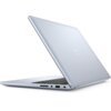 Srebrny laptop z widocznym logo producenta na pokrywie, częściowo otwarty, ukazujący klawiaturę i porty boczne. Na obudowie znajdują się porty USB, gniazdo słuchawkowe oraz czytnik kart pamięci.