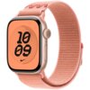 Różowy pasek do zegarka Apple Watch z serii Nike Sport Loop jest przymocowany do zegarka z wyświetlaczem pokazującym godzinę 10:09 na pomarańczowym tle z czarnymi cyframi i logo Nike. Pasek ma teksturowaną powierzchnię i jest wykonany z materiału przypomi