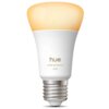 Na zdjęciu znajduje się inteligentna żarówka LED z widocznym napisem "hue white ambiance 1100" na białej obudowie. Górna część żarówki emituje ciepłe, żółtawe światło.