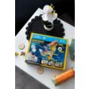 Na zdjęciu znajduje się pudełko z produktem "Puzzle 3D CUBIC FUN National Geographic Mikroskop 306-DS1127H" z kolorową grafiką mikroskopu i informacjami o produkcie, takimi jak "100x!" oraz "8+". Obok pudełka leżą elementy przypominające części układanki,