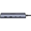 Na zdjęciu widoczny jest szary hub z kilkoma portami, w tym dwoma portami USB Typu A i dwoma portami USB Typu C. Na powierzchni urządzenia znajduje się napis "UGREEN 4K 60Hz".