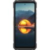 Smartfon z wyświetlaczem prezentującym obraz namiotu oświetlonego na tle górskiego krajobrazu nocą, z odbiciem w wodzie. Produkt to "Smartfon ULEFONE Armor 33 5G 12/512GB 6.95" 120Hz Czarny".