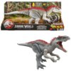 Na zdjęciu znajduje się figurka dinozaura Indominus Rex z kolekcji Jurassic World Legacy, umieszczona na tle opakowania z grafiką lasu. Na opakowaniu widnieje logo Jurassic World oraz napisy: "TRY ME! ESSAIE!", "REIMAGINED", "ELECTRONIC REAL FEEL", "INDOM