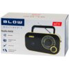 Opakowanie radia przenośnego w kolorze czarno-złotym z widocznym logo "BLOW" oraz napisami: "MULTIMEDIA", "Radio RA12", "Bluetooth", "Analogowe stacje AM/FM", "Jack 3,5 mm", "Zasilanie sieciowe lub bateriami". Na opakowaniu znajduje się również ilustracja radia oraz ikona FM.