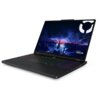 Laptop z otwartym ekranem wyświetlającym grafikę z zamkiem na tle burzowego nieba, z widocznym logo "Lenovo LEGION" w prawym dolnym rogu. Klawiatura podświetlana jest w różnych kolorach.