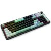 Na zdjęciu znajduje się klawiatura mechaniczna z podświetleniem RGB, z klawiszami w różnych kolorach, w tym miętowym i czarnym. Widoczne są oznaczenia klawiszy, takie jak "Tab", "CapsLK", "Shift", "Ctrl", "Win", "Alt", "Enter", "Shift", "Del", "Home", "Pg