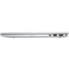 Srebrny laptop widziany z boku, z widocznymi portami: USB-C, USB-A, portem Ethernet oraz gniazdem na kartę SIM. Obudowa jest smukła, a powierzchnia gładka.