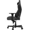 Ciemnoszary fotel gamingowy z regulowanym podłokietnikiem, widoczny z boku, z solidną podstawą na kółkach. Oparcie ma ergonomiczny kształt, a na bocznej części znajduje się logo producenta.