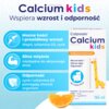 Na zdjęciu znajduje się opakowanie suplementu diety "Calcium kids" o smaku pomarańczowym, wspierającego wzrost i odporność, z grafiką żyrafy i pomarańczy. Widoczne są hasła: "Mocne kości i prawidłowy wzrost", "Silne mięśnie niezbędne do aktywnego dnia!" oraz "Odporność", a także składniki: wapń, witamina D3, cynk.