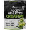 Opakowanie produktu "Kreatyna OLIMP Rocky Athletes Jabłkowy (500 g)" z napisem "Sour Apple Punch Flavour" oraz grafiką zielonych jabłek i rozpryskującej się wody. Na opakowaniu widnieje informacja: "3 g of creatine per portion", "Sugar Free", "121 portion