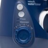Granatowy irygator stacjonarny z widocznym logo "waterpik waterflosser" oraz pokrętłem z numeracją od 2 do 10. Obok pokrętła znajdują się przyciski z oznaczeniami "Floss" i "Massage".