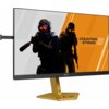 Monitor z cienkimi ramkami wyświetla grafikę z napisem "COUNTER STRIKE 2" oraz postaciami w ciemnych strojach i pomarańczowych okularach. Na dolnej ramce monitora widoczny jest napis "AGON", a podstawa monitora jest złota z oznaczeniem "CS".