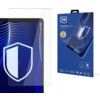 Na zdjęciu widoczny jest produkt "3mk FlexibleGlass Pro" z grafiką przedstawiającą tarczę na ekranie urządzenia oraz opakowanie z logo 3mk i napisami: "Feel the power", "unbreakable hybrid", "9H", "ROHS", "must have". Opakowanie zawiera również piktogramy i certyfikaty związane z produktem.