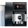 Czarny ekspres do kawy z wyświetlaczem pokazującym ustawienie "Coffee Timer" z napisem "Coffee 6:30 a.m." oraz logo "jura" na srebrnym panelu z oznaczeniem "Z10". Po lewej stronie widoczny jest przezroczysty pojemnik na wodę.