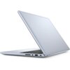 Srebrny laptop z widocznym logo "DELL" na pokrywie, częściowo otwarty, ukazujący klawiaturę i porty boczne. Na obudowie znajdują się porty USB i czytnik kart pamięci.