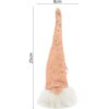 Różowa dekoracja świąteczna w kształcie Mikołaja z długą czapką ozdobioną cekinami, o wysokości 25 cm i szerokości 8 cm. Dolna część dekoracji jest pokryta białym, puszystym materiałem.