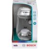 Opakowanie zabawki ekspresu do kawy z logo "BOSCH" i "TASSIMO" na przodzie urządzenia, z białą filiżanką na podstawce. Na opakowaniu widoczne są napisy "klein" oraz "BOSCH", a także oznaczenie wiekowe "3+".