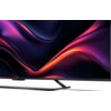 Telewizor z cienką ramką wyświetla dynamiczny, kolorowy wzór w odcieniach fioletu i czerwieni. Na dolnej ramce widoczny jest napis "SHARP".
