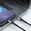 Na zdjęciu widać czarny kabel USB-C podłączony do laptopa oraz smartfona, na którym wyświetla się napis "Charging, 78%". Kabel ma plecioną osłonę i metalowe końcówki.