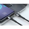 Na zdjęciu widać czarny kabel USB-C podłączony do laptopa oraz smartfona, na którym wyświetla się napis "Charging, 78%". Kabel ma plecioną osłonę i metalowe końcówki.