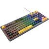 Na zdjęciu znajduje się klawiatura z podświetleniem RGB, z klawiszami w różnych kolorach, w tym żółtym i czarnym. Na klawiaturze widoczne jest logo "Rampage" oraz napisy na klawiszach, takie jak "Esc", "Shift", "Enter" i inne standardowe oznaczenia klawiszy.