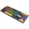 Na zdjęciu znajduje się klawiatura mechaniczna z podświetleniem RGB, posiadająca klawisze w różnych kolorach, w tym żółtym, szarym i czarnym. Na klawiaturze widoczny jest napis "RAMPAGE" oraz dwa pokrętła w prawym górnym rogu.