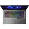 Laptop z widoczną klawiaturą podświetlaną w kolorach tęczy, z ekranem wyświetlającym niebieski, futurystyczny wzór. W prawym górnym rogu ekranu znajduje się logo "Lenovo LOQ".