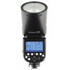 Czarna lampa błyskowa z widocznym ekranem LCD, na którym wyświetlane są ustawienia takie jak "28 mm", "1/128 +0.5", "TTL 0.8", "CH21", oraz przyciski sterujące poniżej. Na obudowie lampy znajduje się napis "STROBOSS V1".