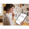 Na zdjęciu widać osobę trzymającą tablet, na którym wyświetlany jest ekran z tekstem: "Document Parsing" oraz "Upload PDF/PPTX file". W tle znajduje się ściana z różnymi obrazkami i dokumentami.