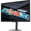 Monitor z logo "GIGABYTE" na dolnej ramce, wyświetlający kolorowy napis "GAMING" na ekranie. W tle widoczne są elementy graficzne przypominające futurystyczne wzory.