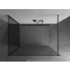 Na zdjęciu widoczna jest ścianka prysznicowa typu walk-in o wymiarach 110 x 70 cm, wykonana z transparentnego szkła z metalowymi elementami w kolorze gun metal. Ścianka jest zamontowana w nowoczesnej łazience z szarymi, betonowymi ścianami i sufitem.