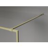 Złota szczotkowana ścianka prysznicowa z ramką i wspornikiem, zamontowana na szarej ścianie. Produkt ma minimalistyczny design i jest wykonany z przezroczystego szkła o grubości 8 mm.