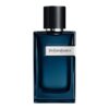 Ciemnoniebieska butelka perfum z czarnym korkiem, na której widnieje napis "Yves Saint Laurent".