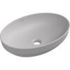 Popielata, matowa umywalka nablatowa o owalnym kształcie z otworem odpływowym na dnie. Na wewnętrznej stronie widoczne jest logo "Mexen".