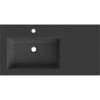 Czarna matowa umywalka wpuszczana w blat z otworem na baterię i odpływ, o prostokątnym kształcie. W lewym górnym rogu widoczne jest logo "Mexen".