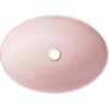Owalna, różowa matowa umywalka nablatowa z centralnym otworem odpływowym. Na krawędzi umywalki widoczne jest logo "MEXEN".