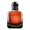 Butelka perfum o bursztynowym kolorze z napisem "STRONGER WITH YOU ABSOLUTELY" oraz logo "EMPORIO ARMANI" na dole. Korek butelki jest ciemny i błyszczący, z metalicznymi akcentami.