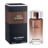 Na zdjęciu widoczna jest butelka perfum oraz pudełko z napisem "BOIS D'AMBRE LES PARFUMS MATIÈRES". Na dole pudełka znajduje się tekst "KARL LAGERFELD EAU DE TOILETTE 100 ml e 3.3 FL.OZ".
