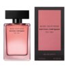 Na zdjęciu widoczna jest różowa butelka perfum z czarnym korkiem, na której znajduje się napis: "Musc Noir Rose narciso rodriguez for her". Obok butelki znajduje się różowe opakowanie z tym samym napisem oraz dodatkowymi informacjami: "eau de parfum 1.6 fl. oz. 50 ml".