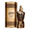 Złoty flakon w kształcie torsu z poziomymi prążkami stoi obok cylindrycznego opakowania z napisem: "Jean Paul Gaultier 'Le Male' Elixir".
