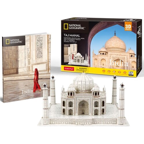 Na zdjęciu znajduje się zestaw puzzli 3D przedstawiający Taj Mahal, składający się z 87 elementów, z logo National Geographic i CubicFun. Obok modelu widoczna jest okładka książki z napisem "India" oraz pudełko z napisem "TAJ MAHAL" i ostrzeżeniem "WARNIN