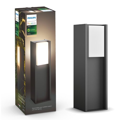 Pudełko z lampą zewnętrzną marki Philips Hue Turaco, z widocznym logo "PHILIPS" oraz napisami "hue", "White", "Outdoor" i "Turaco Pedestal". Obok znajduje się sama lampa o prostokątnym kształcie z jasnym panelem świetlnym na górze.