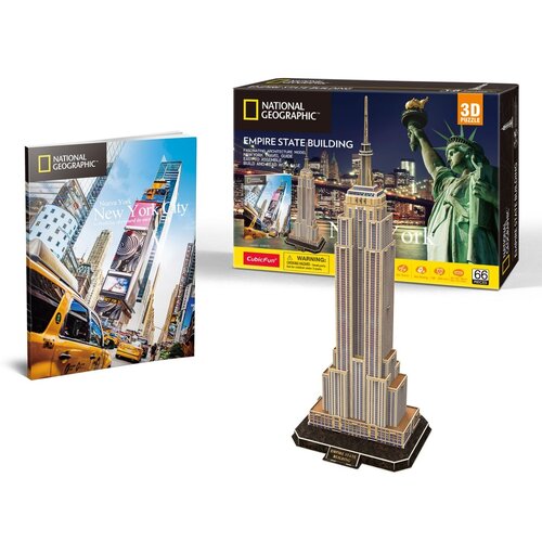 Na zdjęciu znajduje się model 3D Empire State Building oraz pudełko z napisem "National Geographic Empire State Building" i "3D Puzzle". Obok widoczna jest książka z okładką przedstawiającą Nowy Jork i żółtą taksówkę, z napisem "New York City".