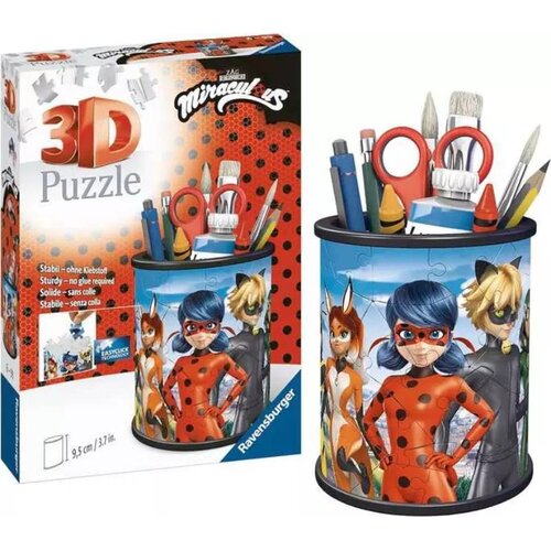 Na zdjęciu znajduje się opakowanie oraz złożony produkt "Puzzle 3D RAVENSBURGER Miraculous Przybornik 11278 (54 elementy)". Na opakowaniu widnieje napis "3D Puzzle" oraz "Sturdy - no glue required", a także logo "Ravensburger".