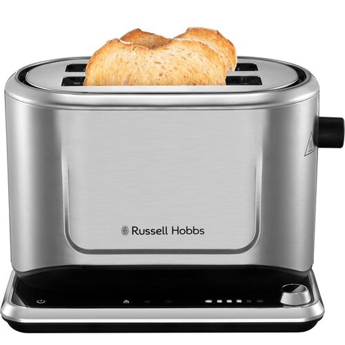 Na zdjęciu widoczny jest toster z dwoma kromkami chleba, wykonany ze stali nierdzewnej, z logo "Russell Hobbs" na przedniej części. Toster ma czarną podstawę z przyciskami i pokrętłem do regulacji.