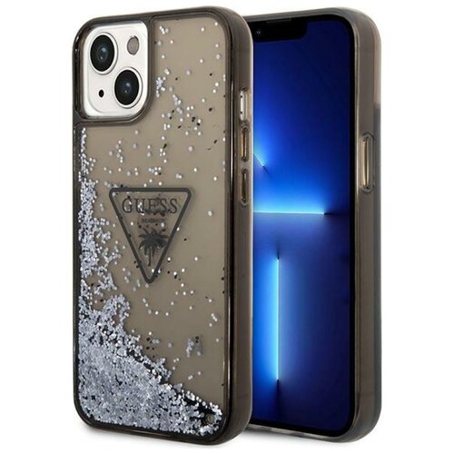Etui na telefon z przezroczystego materiału, ozdobione srebrnym brokatem i białymi drobinkami, posiada trójkątne logo z napisem "GUESS" oraz grafiką palmy. Obok etui widoczny jest telefon z wyświetlaczem emitującym niebieskie światło.