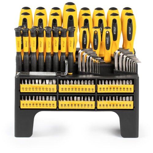 Zestaw wkrętaków składający się z różnych elementów, w tym wkrętaków z żółto-czarnymi uchwytami, kluczy imbusowych oraz bitów, umieszczony na czarnym stojaku z żółtymi oznaczeniami. Widoczne oznaczenia na bitach to m.in. PH0, PH1, PH2, T6, T8, H2, H2.5, H3, S0, S1, S2, S3.